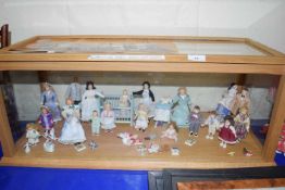 Display cabinet containing a collection of various small dolls from the Scenes of Victorian Life