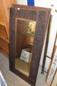 Pair of bevelled wall mirrors in heavily carved frames