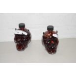 Two small devils head shaped bottles marked MGF