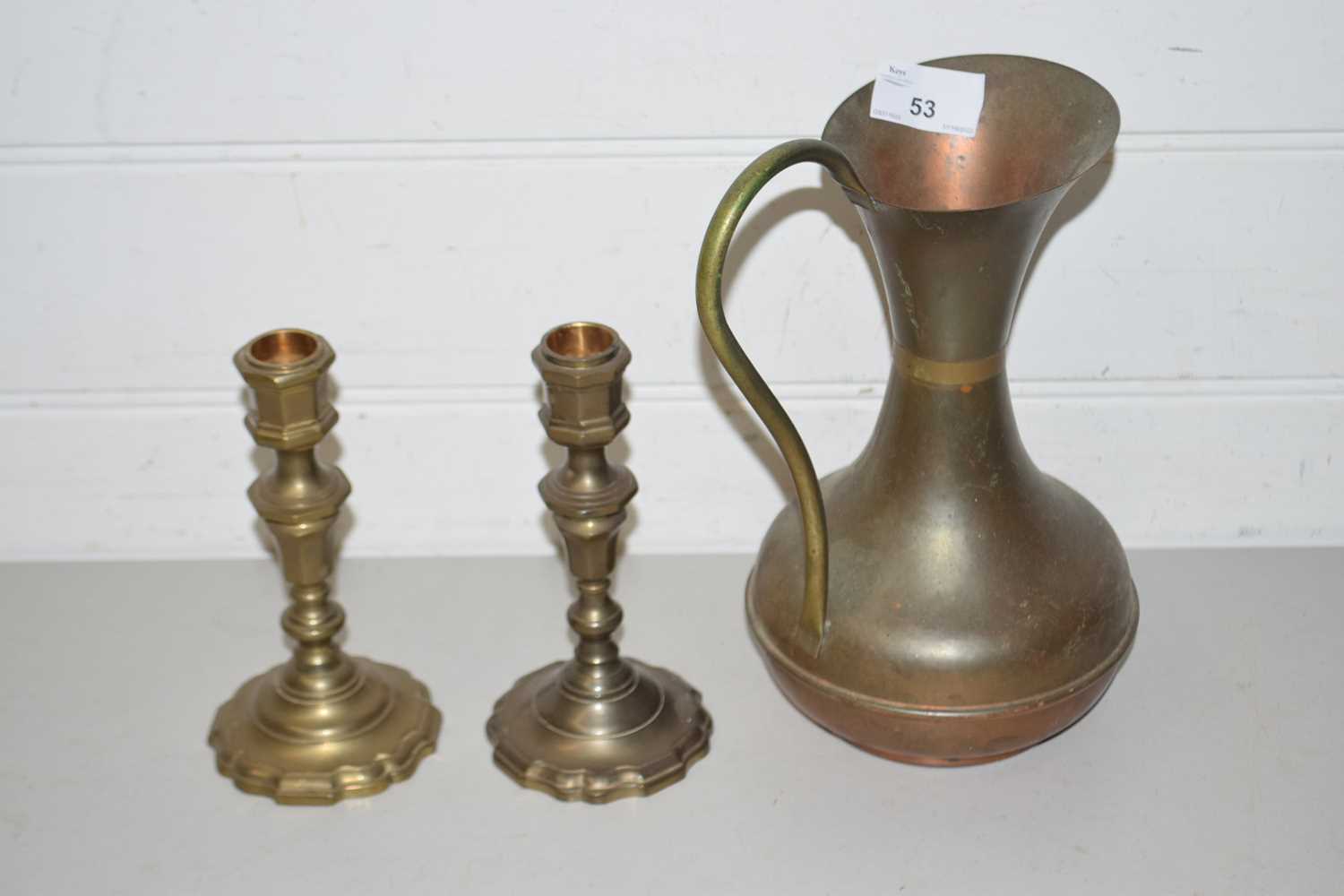 Pair of brass candlesticks and a copper jug