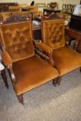 Pair of late Victorian button upholstered chairs, the frames with carved floral decoration