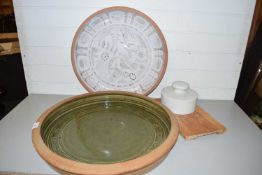 Two large circular glazed serving bowls and a further cheese board