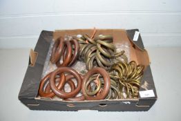 Box of various brass and wood curtain rings