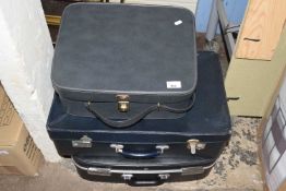 Three assorted suitcases