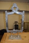 Modern cast metal free standing frame with floral decoration