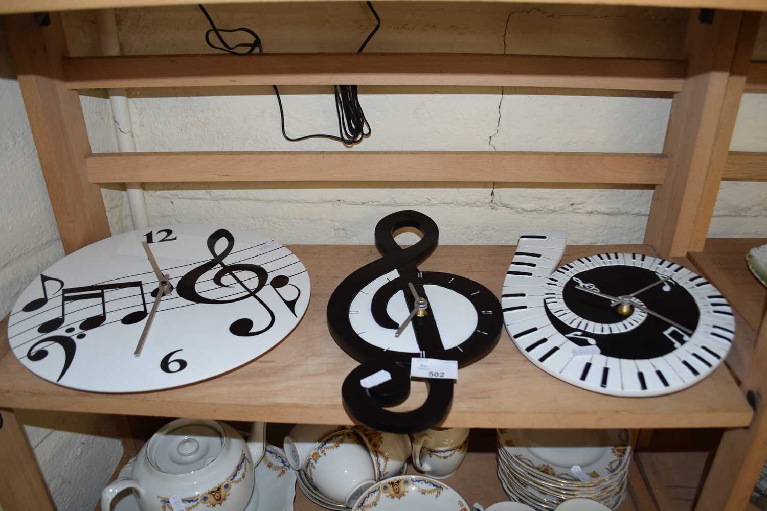 Three modern battery wall clocks decorated with musical notes