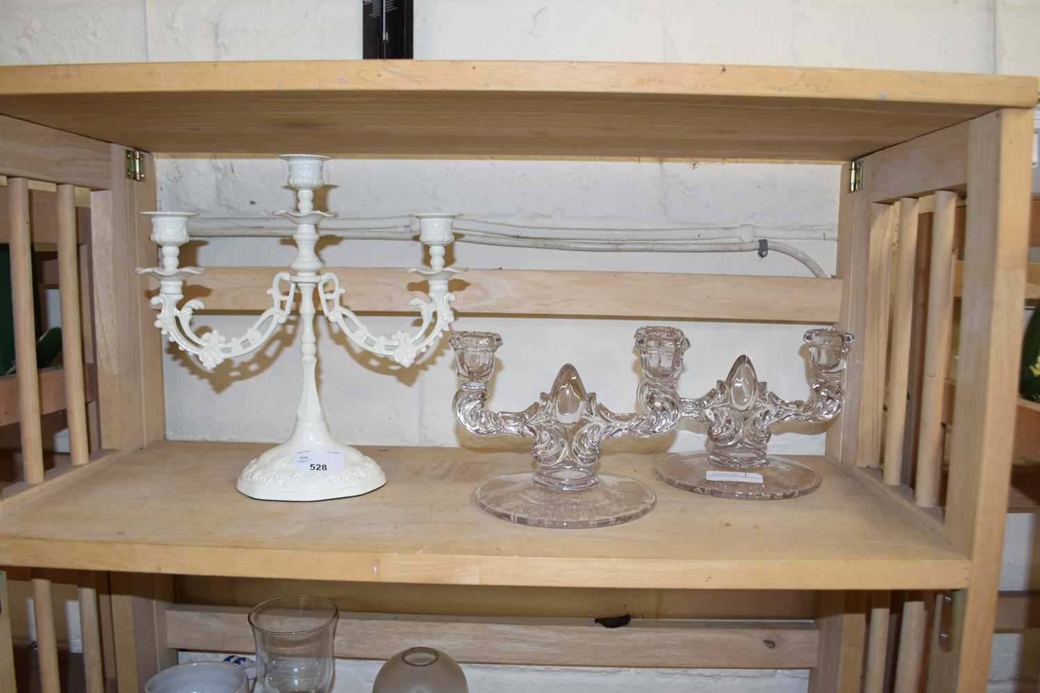 Pair of clear glass candlesticks together with a modern cream painted metal candleabra (3)