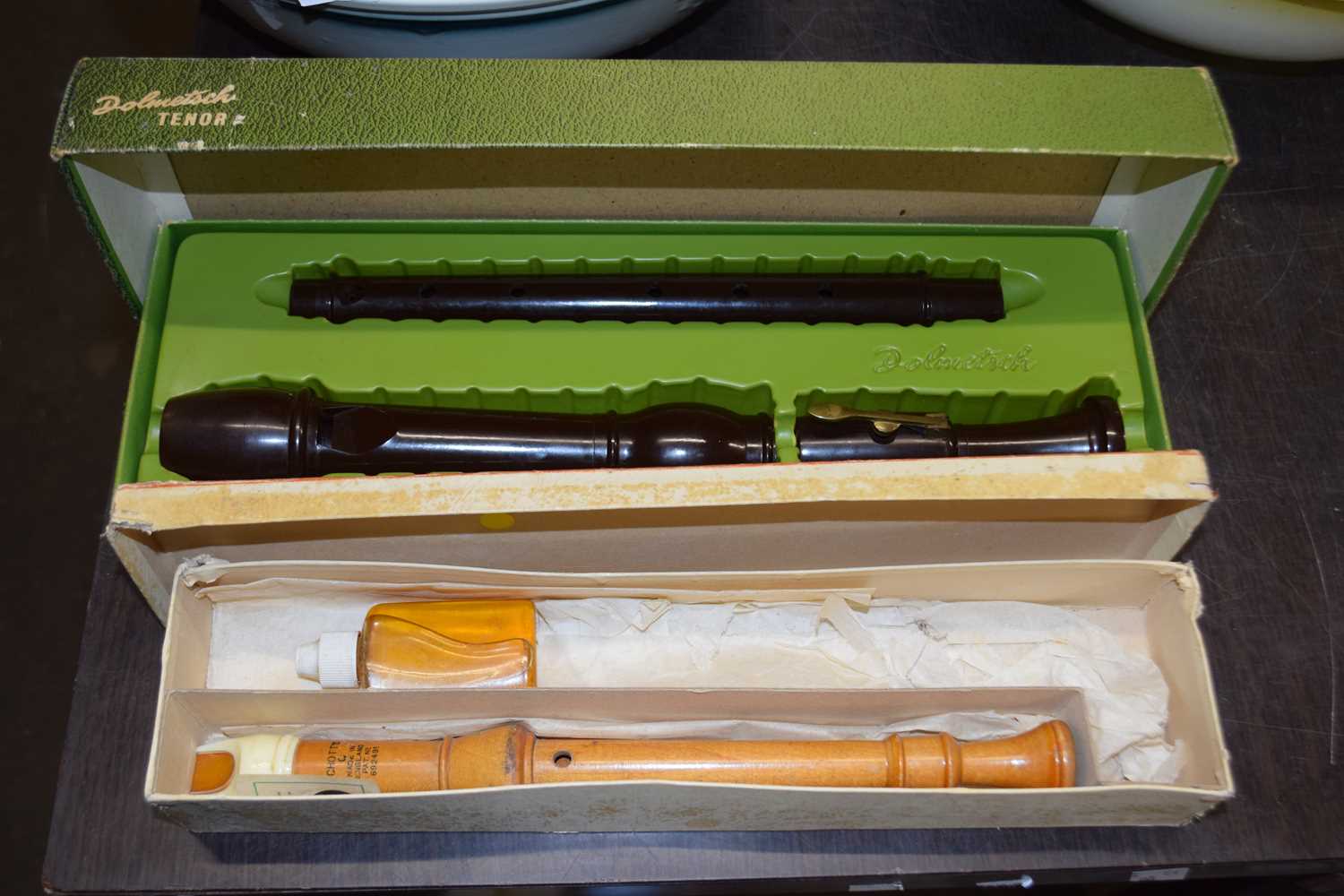 Two boxed recorders, one is a Dolmetsch Tenor and the other is an Adler