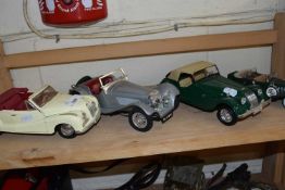 Four various vintage toy cars to include Maisto