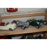 Four various vintage toy cars to include Maisto