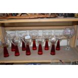 Set of modern red stemmed wine glasses and a further floral decorated over sized wine glass