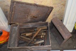 Wooden tool chest containing various assorted chisels, augers and other items