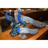 Three resin model peacocks