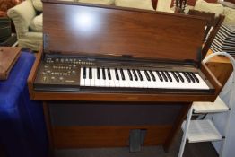 Yamaha CN-1000 keyboard and a leather case of assorted sheet music