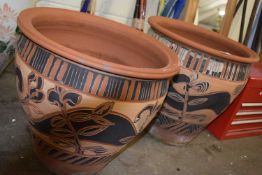 Pair of terracotta plant pots with floral design