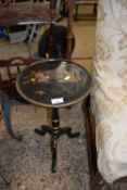 Small early 20th Century black laquered pedestal wine table with Oriental decoration