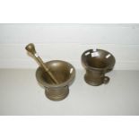 Two antique bronze mortars together with a single pestle