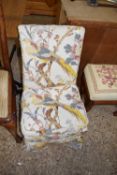 Small upholstered bedroom chair decorated in pheasant covered fabric