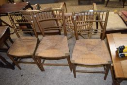 Set of three Morris style rush seated faux bamboo spindle back chairs