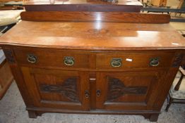 Late Victorian oak bow front side board with carved decoration