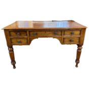 Victorian mahogany five drawer desk or dressing table raised on turned legs, 120cm wide