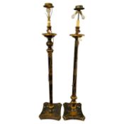 Two similar early 20th Century black lacquered standard lamps painted with Oriental detail,