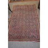 Small Middle Eastern wool rug decorated with a large central panel of geometric design, 187 x 119cm