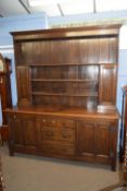 Early 20th Century oak dresser with shelved back over a base with two panelled doors and three