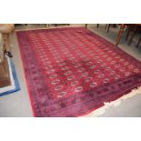 20th Century red Bokhara rug of large proportions, 273 x 367cm