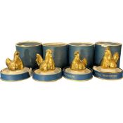 Set of four Royal Worcester egg cup holders, the tops modelled in gilt as chickens, the four all