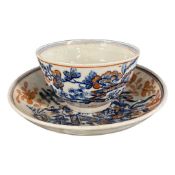 Lowestoft tea bowl and saucer with blue printed designs and iron red over glaze decoration