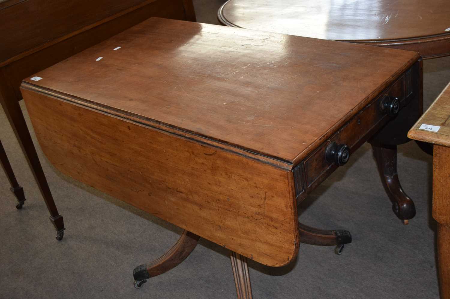 19th Century mahogany pedestal Pembroke table raised on turned column and out swept legs with