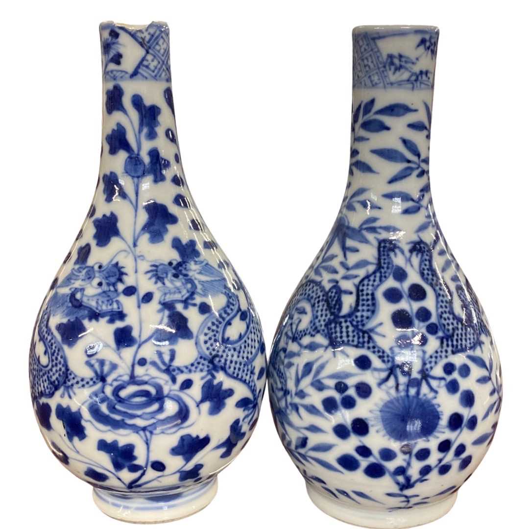 Pair of Chinese porcelain bottle vases with blue and white design of dragons, 15cm high (chip to rim