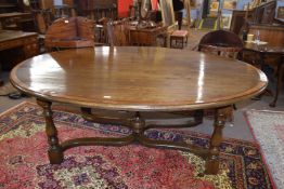 Large good quality reproduction oak and mahogany cross banded oval dining table set on a base with