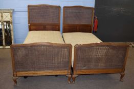 Pair of early 20th Century mahogany and cane single bed frames