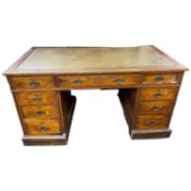 Late Victorian oak twin pedestal desk with leather inset writing surface and nine drawers, 138cm