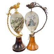 Pair of unusual painted glass egg shaped scenes with Chinese figures, the glass mounted on wooden