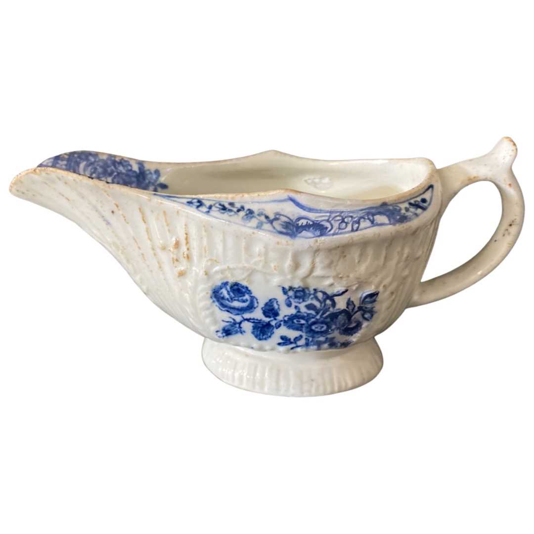 Lowestoft porcelain sauce boat decorated in blue with floral prints
