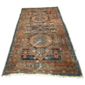 Antique Middle Eastern wool floor rug decorated with a large central panel with two large