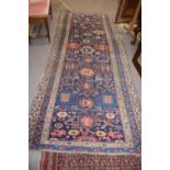 Antique Middle Eastern wool runner carpet with a large central panel decorated with geometric motifs