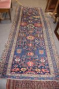 Antique Middle Eastern wool runner carpet with a large central panel decorated with geometric motifs