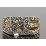 Yellow metal and diamond designer ring having the initials 'RE' highlighted with small diamonds