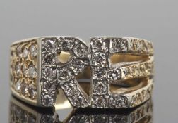 Yellow metal and diamond designer ring having the initials 'RE' highlighted with small diamonds