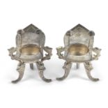 An unusual pair of 20th Century Chinese export silver salts of slipper form, each raised on three