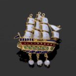 Clipper sailing ship brooch decorated with white, red, and green and blue enamels, with three