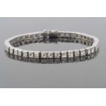 Diamond line bracelet featuring forty five brilliant old round cut diamonds each individually claw