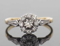 Diamond cluster ring, the centre diamond 0.10ct approx, raised above a small single cut diamond