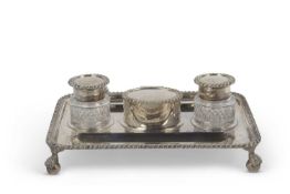 George V ink stand of shaped rectangular form having heavy gadrooned rim, central hinged compartment