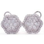 Pair of diamond cluster earrings, the centres with 7 round brilliant cut diamonds raised above a