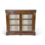 Victorian walnut bookcase cabinet with two glazed doors opening to a shelved interior raised on a
